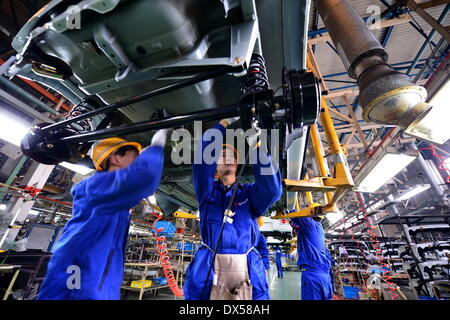 Nanchang, China. 18 March 2014. Workers work on an assembly line in Changhe Automobile Co. in east China's Jiangxi Province, March 12, 2014. In 2013, Beijing Automotive Group (BAIC), China's fifth-largest auto maker by sales, signed an agreement to pay about 80 million yuan (13 million U.S. dollars) for a 70-percent stake in Changhe Auto. The Jiangxi-based automaker expects to expand its yield capacity to 180,000 units in 2014, rising 60 percent year-on-year. © Xinhua/Alamy Live News Stock Photo