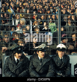 football, Bundesliga, 1973/1974, Ruhr Stadium, VfL Bochum versus FC Schalke 04 2:5, visitors, football fans, policemen, crowd barrier Stock Photo