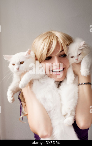 Girl holding cats Stock Photo