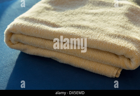 Towel folded on a bed Stock Photo