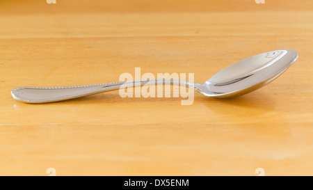 Spoon on wooden table, cutlery Stock Photo