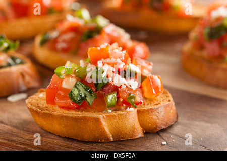 Homemade Italian Bruschetta Appetizer with Basil and Tomatoes Stock Photo