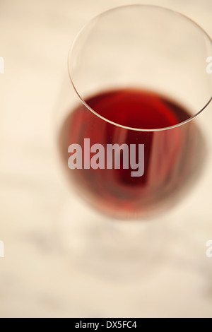 Red wine in wine glass on white background, high angle view, close up