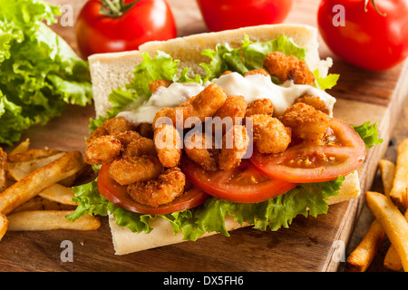 Homemade Shrimp Po Boy Sandwich with French Fries Stock Photo