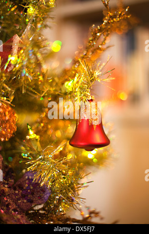Red bell ornament hanging on Christmas tree, close up Stock Photo