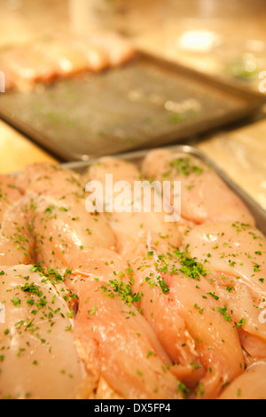 Raw, seasoned chicken ready to cook, close up Stock Photo