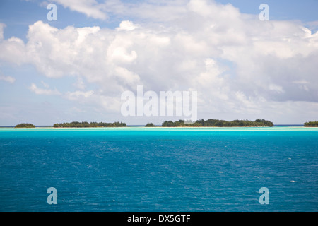 Tahitian blue ocean seascape under blue sky with clouds Stock Photo