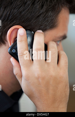 Man holding cell phone to ear and talking, close up Stock Photo