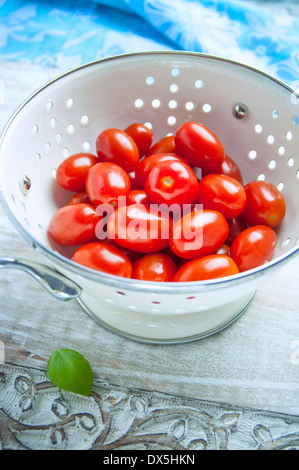 Grape Tomatoes in a White Strainer Stock Photo