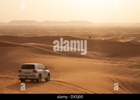 Dubai Desert safari holiday tour in the Arabian desert with 4X4 car at sunset, Dubai, UAE, United Arab Emirates, Middle East Stock Photo