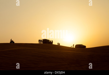 Dubai desert safari - people watching the sunset from the dunes, Arabian Desert, Dubai, UAE, United Arab Emirates, Middle East Stock Photo