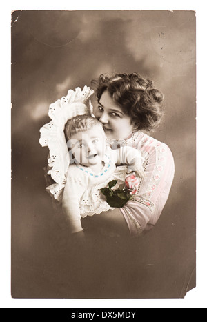 BERLIN, GERMANY - CIRCA 1915: antique portrait of lucky mother with her cute baby wearing vintage clothing, circa 1915 in Berlin Stock Photo