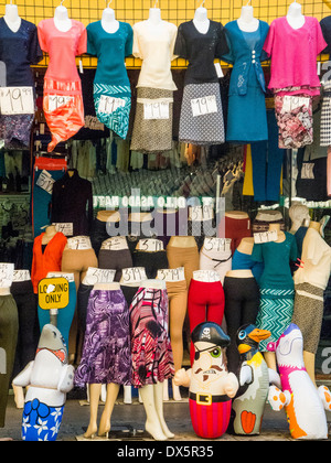 Displayed on partial body mannequins, a sidewalk clothing sale in the Los Angeles garment district has a surrealist look. Note hand written price tags. Stock Photo