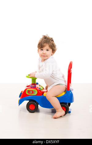 Fashionable boy holding a toy car in his hands, isolated on a white studio  background. A handsome child dreaming of a real car. Dreams of a child  about racing. 26460318 Stock Photo