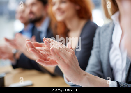 Cropped image of a businessperson applauding on the foreground Stock Photo