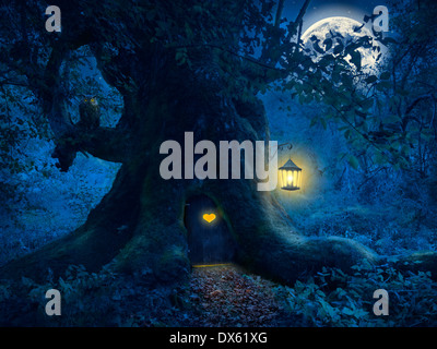 Magical night with a little home in the trunk of an ancient tree in the enchanted forest. Stock Photo