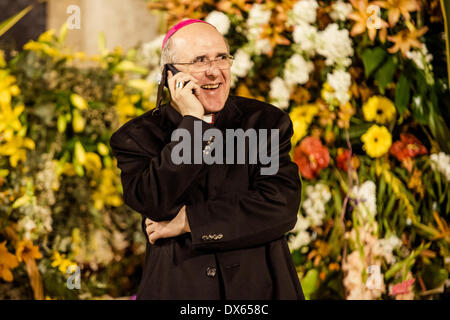 Valencia, Spain. March 18th, 2014: The archbishop of Valencia, Carlos Osoro, talks with someone by mobile phone while he attends the Ofrenda Floral Credit:  matthi/Alamy Live News Stock Photo