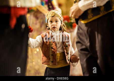 Valencia, Spain. March 18th, 2014: A little Fallero finally offers her flower bouquet to the Virgin and hands it over to be placed at the virgins image. Credit:  matthi/Alamy Live News Stock Photo