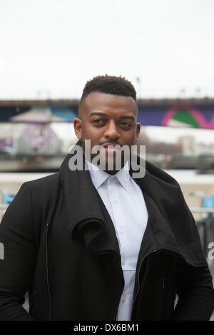 London, UK, 19th Mar, 2014. JLS star Oritsé Williams launches Water Aid's campaign by adding first 'watergraph' to pledge his support for World Water Day outside the Canary Wharf Tube station. Credit:  Steve Bright/Alamy Live News Stock Photo