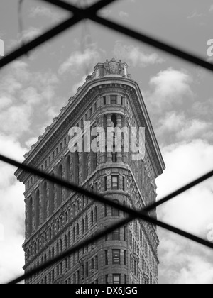 The Flatiron Building viewed through a fence, New York Stock Photo