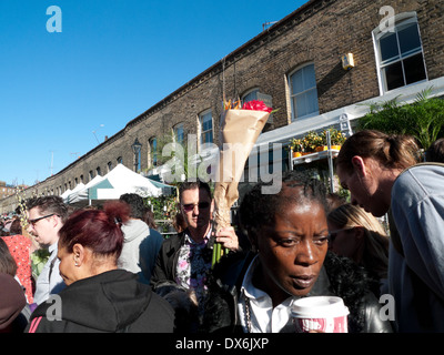 Multicultural ethnically diverse crowd of ethnic people walking through street  at Columbia Road Flower Market London E2 England UK  KATHY DEWITT Stock Photo