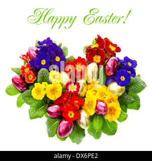 colorful primula flowers with easter eggs decoration isolated on white background. spring flowers bouquet in heart shape. Stock Photo