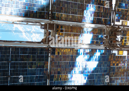 This close-up picture of a Zvezda Service Module array of the International Space Station, reflecting bright rays of the sun Stock Photo