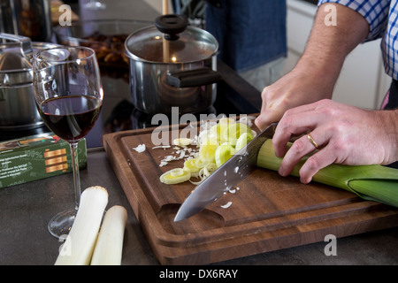 Couple is cooking at home in their kitchen. Preparing a meal. Stock Photo