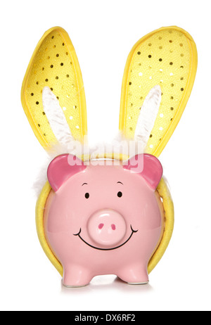 Piggy bank wearing easter bunny ears cutout Stock Photo
