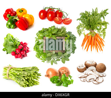 blank green blackboard with variety fresh herbs and vegetables isolated on white background. Stock Photo