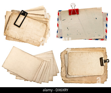 pile of old postcards isolated on white background. vintage paper sheets with clip. air mail envelope. retro design Stock Photo