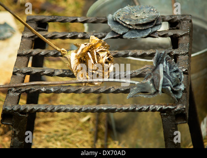 Three pretty shiny Golden rose, forged from metal. Manual work. Stock Photo