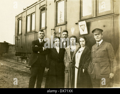 Circa 1920 photograph, a group from the American YMCA stand in front of a Prussian Abteilwagen train car in Poland. Stock Photo