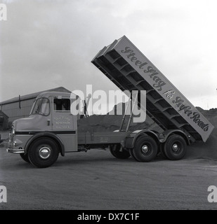 Historical picture 1950s of a steel slag truck tipping out its load at a mill or yard, Sheffield, England. Stock Photo