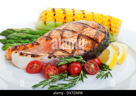 grilled salmon steak with vegetables corn and asparagus Stock Photo