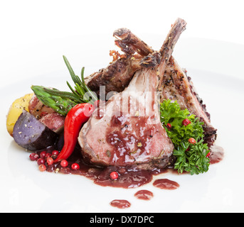 Roasted Lamb Chops with Vegetables,potato and asparagus.focus on the front chop. Stock Photo