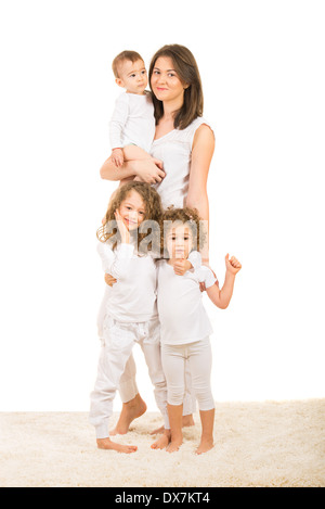 Happy family of four members standing on fur carpet home Stock Photo