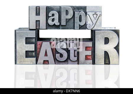 Happy Easter in old metal letterpress printing blocks with mixed font, isolated on a white background. Stock Photo