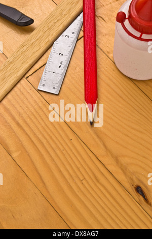 Do it yourself material and equipment: Material used by a handyman: glue, pencil, ruler and cutting or utility knife. Stock Photo