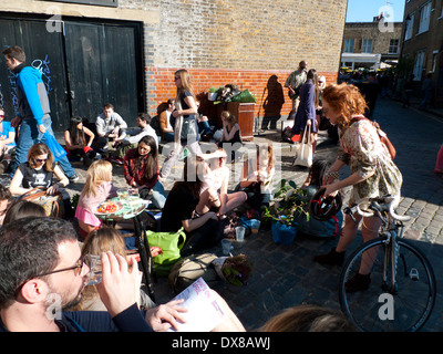 Crowd of young people on Sunday at Ezra Street near Columbia Road Flower Market London E2 UK KATHY DEWITT Stock Photo