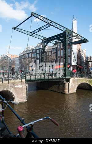 Cast iron swing bridge with cyclists and pedestrians amsterdam netherlands Stock Photo