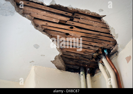 Plaster fallen away from a water damaged ceiling UK Stock Photo