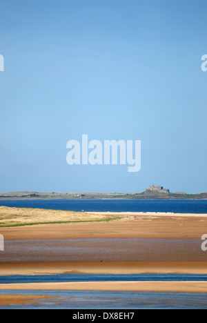View of Lindisfarne over Budle Bay, Northumberland Stock Photo