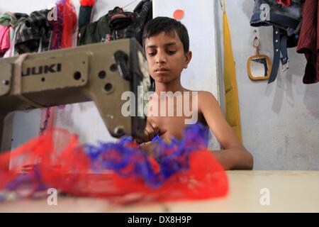 Dhaka 20 march 2014.The number of children working at different tailors’ shops in Keraniganj on the outskirts of the capital in Dhaka .The children, some preteens, works only for tips and get no salaries in small businesses that have no fire safety measures. Stock Photo