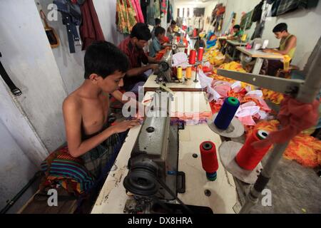 Dhaka 20 march 2014.The number of children working at different tailors’ shops in Keraniganj on the outskirts of the capital in Dhaka .The children, some preteens, works only for tips and get no salaries in small businesses that have no fire safety measures. Stock Photo