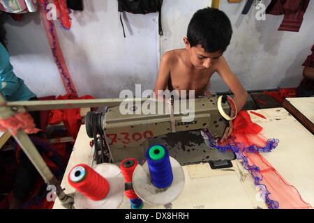 Dhaka 20 march 2014.The number of children working at different tailors’ shops in Keraniganj on the outskirts of the capital in Dhaka .The children, some preteens, works only for tips and get no salaries in small businesses that have no fire safety measures. Stock Photo