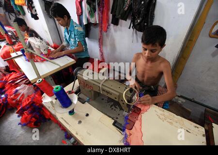 Dhaka 20 march 2014.The number of children working at different tailors’ shops in Keraniganj on the outskirts of the capital in Dhaka .The children, some preteens, works only for tips and get no salaries in small businesses that have no fire safety measures. Stock Photo