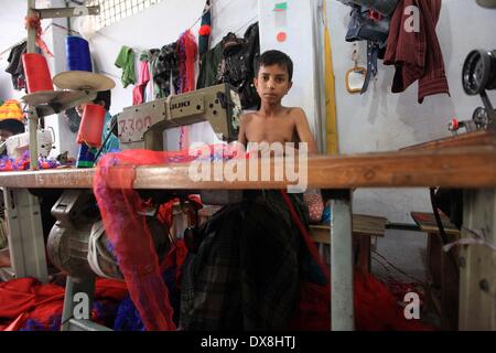 Dhaka 20 march 2014.The number of children working at different tailors’ shops in Keraniganj on the outskirts of the capital in Dhaka .The children, some preteens, works only for tips and get no salaries in small businesses that have no fire safety measures. Stock Photo