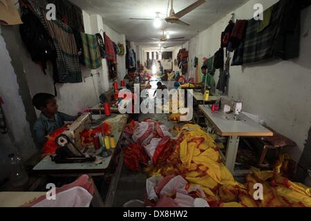 Dhaka 20 march 2014.The number of children working at different tailors’ shops in Keraniganj on the outskirts of the capital in Dhaka .The children, some preteens, works only for tips and get no salaries in small businesses that have no fire safety measures. Stock Photo