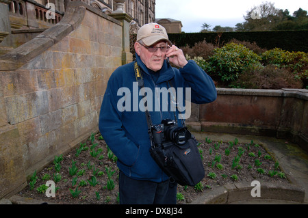 A Photographer Using His Mobile Phone.4.. Stock Photo